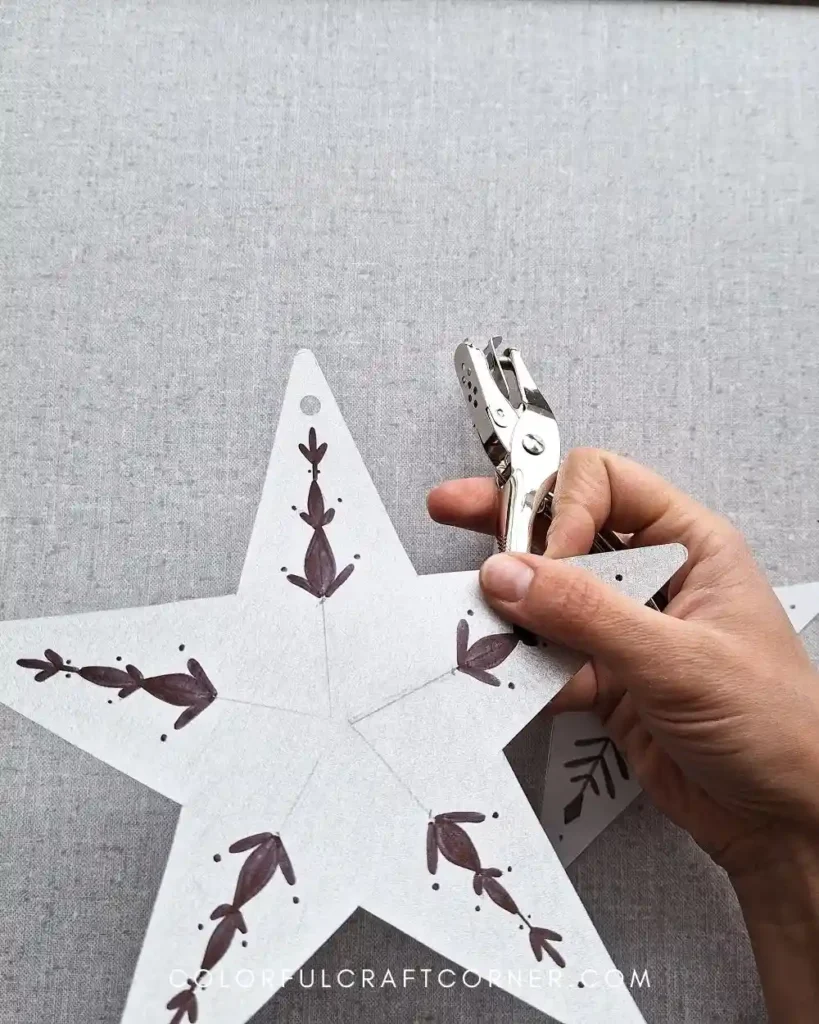 punching a hole in shrink plastic ornaments before shrinking