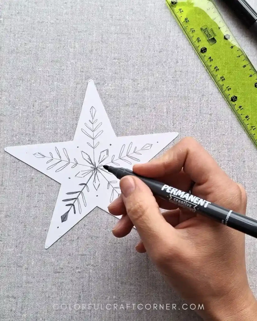 drawing designs on shrink plastic stars with markers